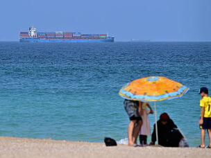 A cargo ship is pictured off coast of the Khor Fakkan Container Terminal, the only natural deep-sea port in the region and one of the major container ports in Sharjah Emirate, along the Gulf of Oman on Sunday.