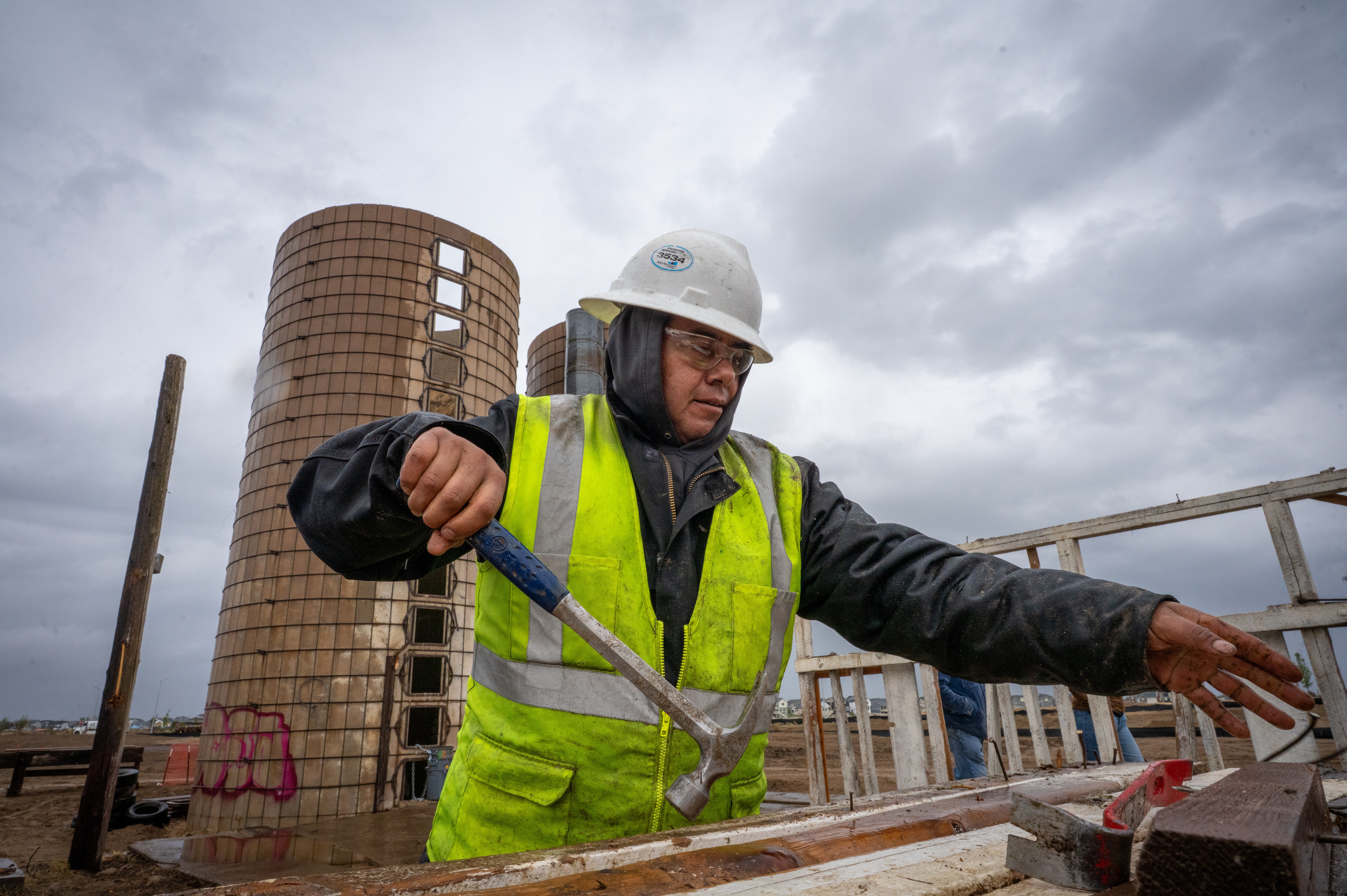 On the site of a former ranch slated for housing development on the outskirts of Aurora, Colo., Pedro Macedo of Perks Deconstruction pulls nails from a wood frame that once stood in a barn.