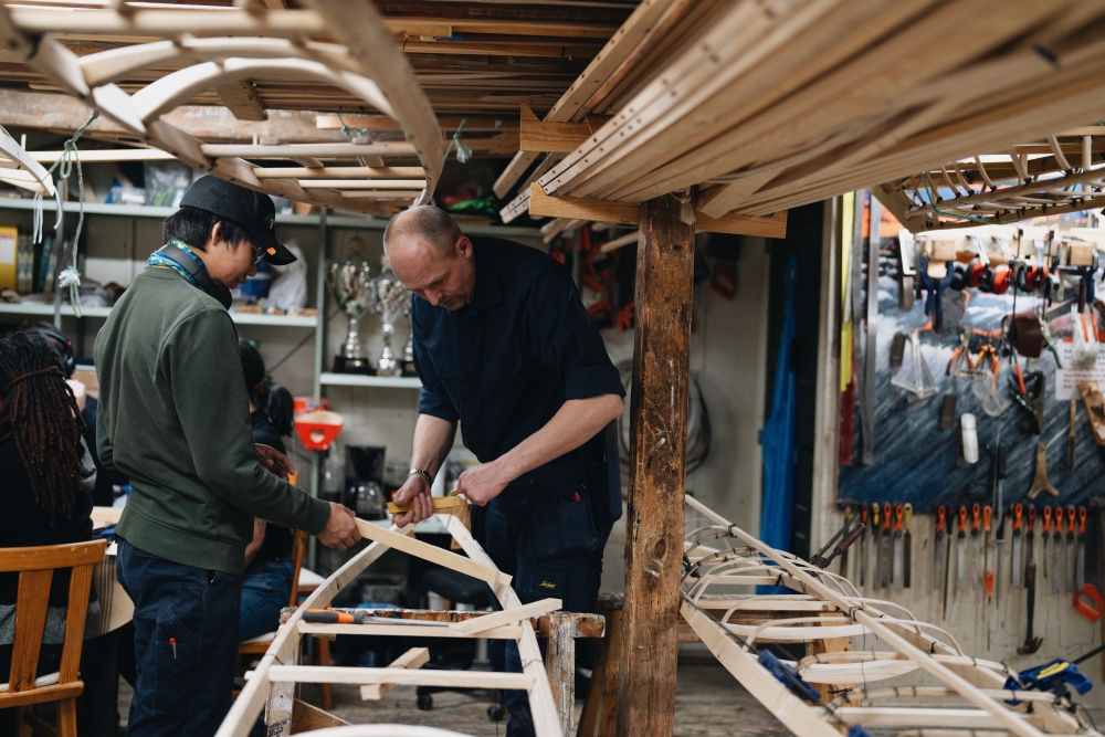 Members of the kayak club in Nuuk gather on a Tuesday night to work on building their kayaks.