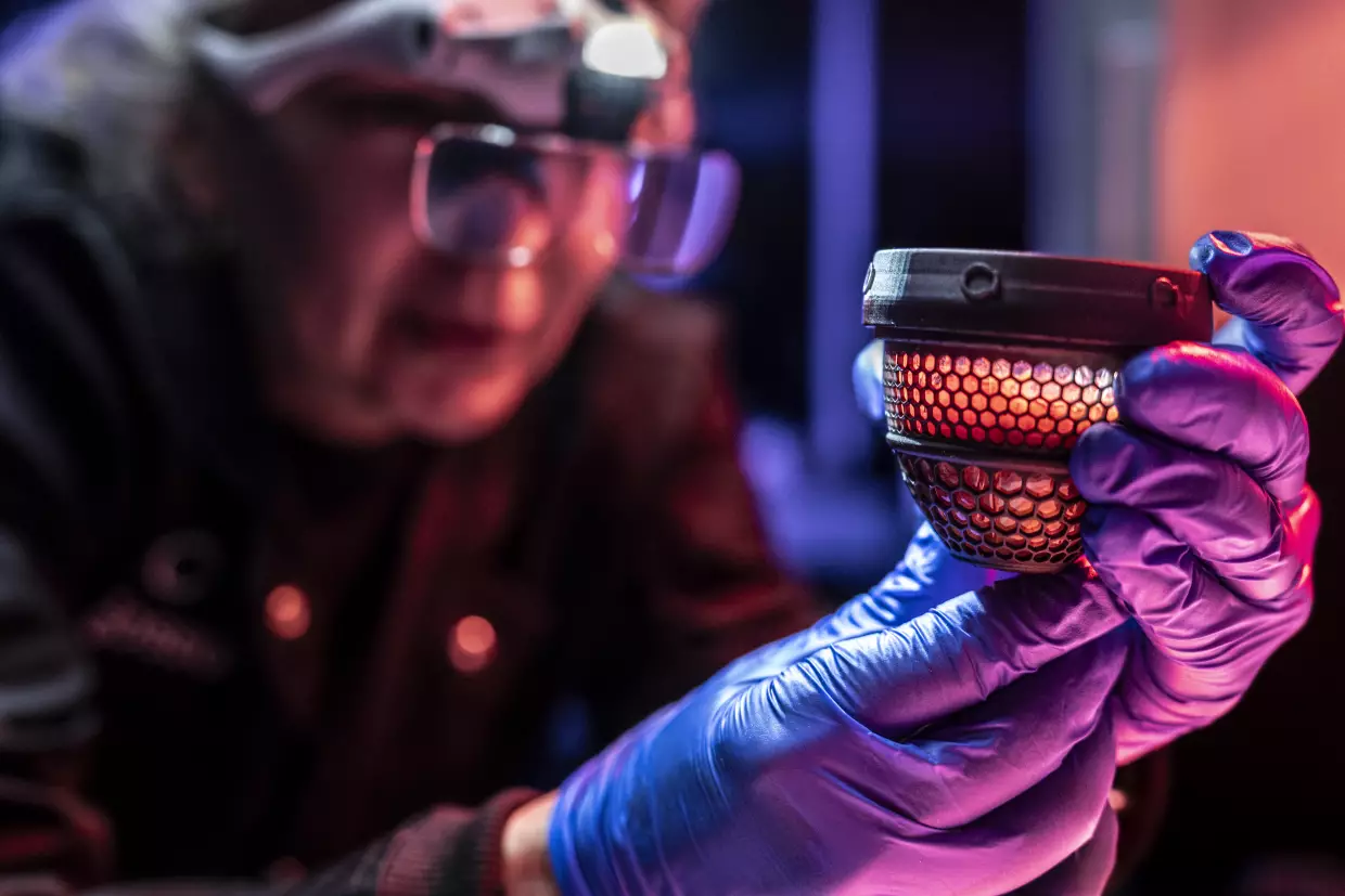 A Colossal Biosciences worker performs a wellness check on an artificial egg.