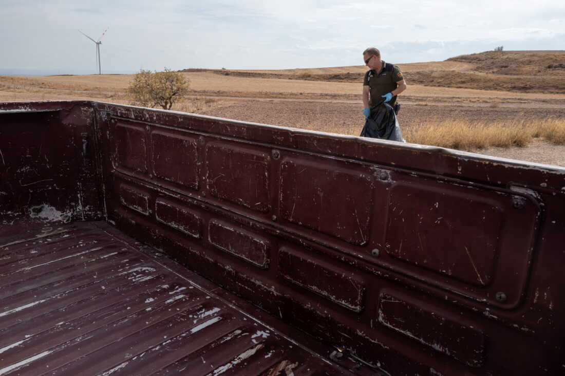RUEDA DE JALÓN, SPAIN - SEPTEMBER 27, 2026 Juan Ballesteros, an agent with the Protección de la Naturleza (Environmental Protection) removes a dead vulture, killed by a wind turbine in Rueda de Jalón, Spain on September 27, 2026. The Spanish region of Aragon is seeing a huge surge in data center construction, solar panel farms, and wind turbines which has alarmed many local residents with the high energy use, noise pollution, danger to wildlife, and heat generation they are known for. Ornithologists and Natural Resouce agents with the Aragon government are concerned about the lethal impact that the giant windmills have on the fragile bird popluation, including raptors and vultures, in the area. (Photo by Michael Robinson Chávez for National Public Radio)