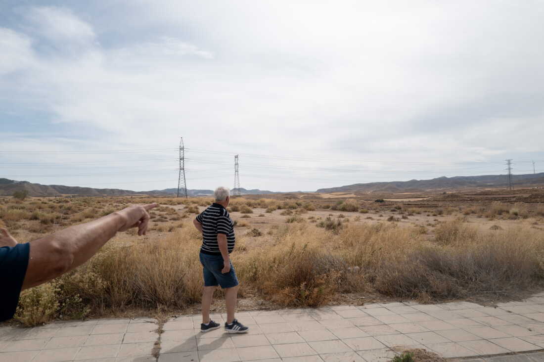 BOTORRITA, SPAIN - SEPTEMBER 28, 2026 Residents point to an area that is to be developed into a data center complex in Botorrita, Spain on September 28, 2026. The work is being done by Merlin, a Spanish property company that claims the project to be “self-consumption.” Neighbors are skeptical. The Spanish region of Aragon is seeing a huge surge in data center construction which has alarmed many local residents due to their high energy use, noise pollution and heat generation. Amazon alone is building 30 data center buildings, according to papers the company filed with the regional government. The Aragon regional government has offered Amazon, Microsoft, and other tech companies tax breaks to build there. Local residents say that the government has appropriate land agains the will of the owners to pave the way for the centers and their infrastructure to be built. (Photo by Michael Robinson Chávez for National Public Radio)