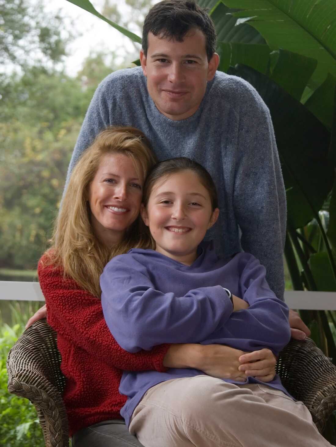 A family photo shows Sophie as a young teen with her parents. 
