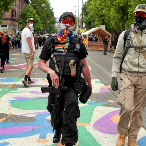 An armed man walks through CHOP in Seattle on June 20, 2020. “I’m here to de-escalate,” he said. “I don’t want to have to fire this for any reason.”