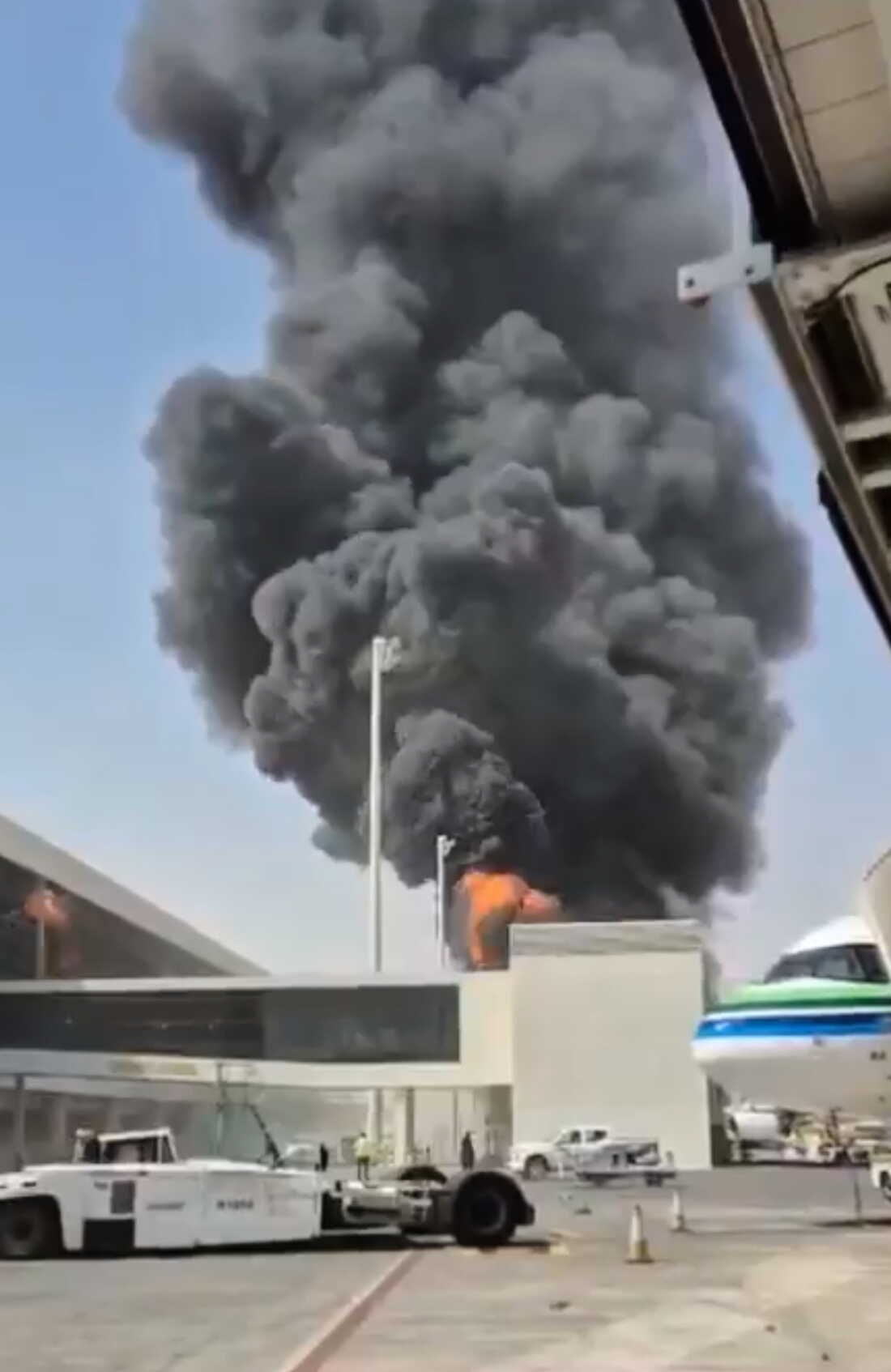 This image from video obtained and verified by AP shows thick black smoke and flames rising from a fire at King Khalid International Airport in Riyadh, Saudi Arabia, Friday, Oct. 9, 2026.