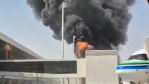 This image from video obtained and verified by AP shows thick black smoke and flames rising from a fire at King Khalid International Airport in Riyadh, Saudi Arabia, Friday, Oct. 9, 2026.