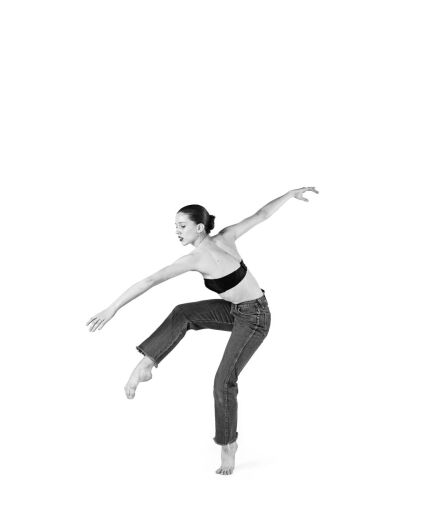 A black and white photo shows a woman dancing.