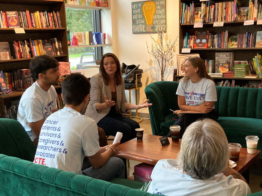 Christina Bohannan, center, chats with Cancer Action Network volunteers at Sidekick Coffee & Books on Aug. 14, 2026.
