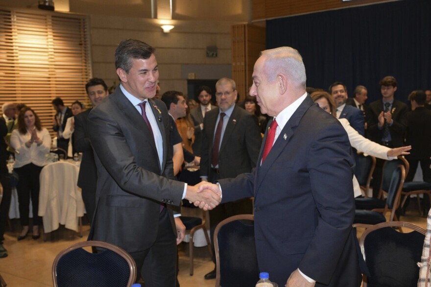 Paraguay's President Santiago Pena, left, shakes hands with Israeli Prime Minister Benjamin Netanyahu in Jerusalem, Thursday, Dec. 12, 2024. 