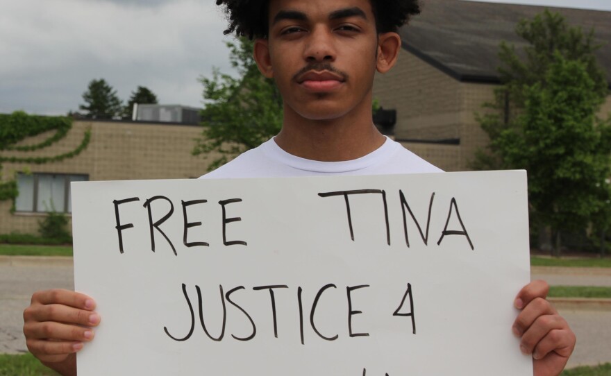 young man holding a sign