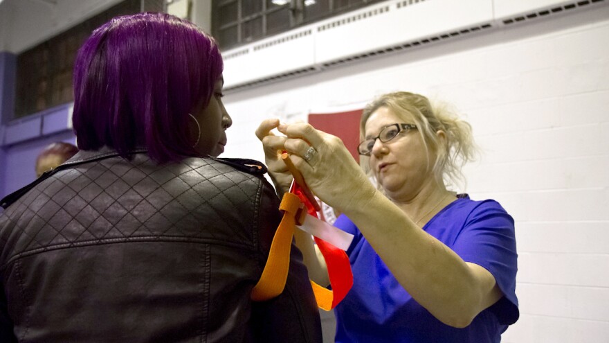 Registered nurse Danielle Vetter demonstrates use of a tourniquet.