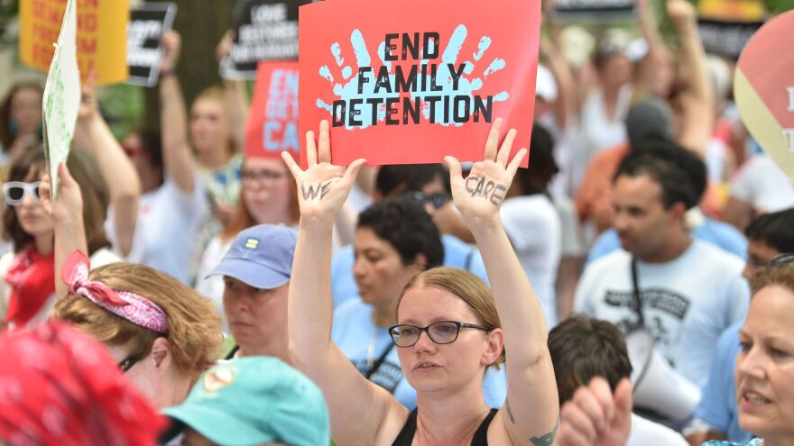 People demonstrate in Washington, D.C., on Thursday, demanding an end to the separation of migrant children from their parents. On Friday, the Justice Department said in a court filing that "the government will not separate families but detain families together during the pendency of immigration proceedings."