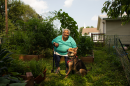 Louise Lynch and her service dog, Paco, at her garden in Kansas City, Kansas. 