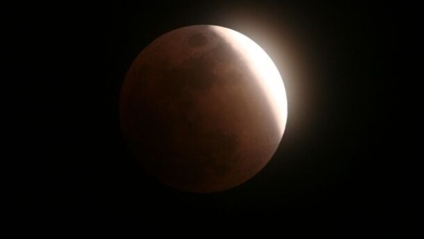 A photo from a previous year's lunar eclipse shows what to expect about midnight on Aug. 27-28 for the partial lunar eclipse.