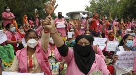 Female community health care workers protest in New Delhi, India, in August 2020. The women are part of a government program called Accredited Social Health Activists — and are demanding higher pay and better working conditions. In May, the program won an award from the World Health Organization.
