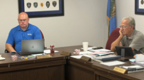 Jeff Russell and Mike Brown, two of the board members of the Oklahoma Police Pension and Retirement System, listen during a meeting on Wednesday, July 15, 2026, in Oklahoma City. In between them is an empty place for fellow OPPRS board member and GOP gubernatorial candidate Mike Mazzei.