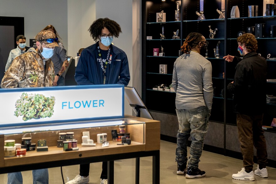 Customers look at different products inside Ascend's Fairview Heights dispensary on March 25, 2021