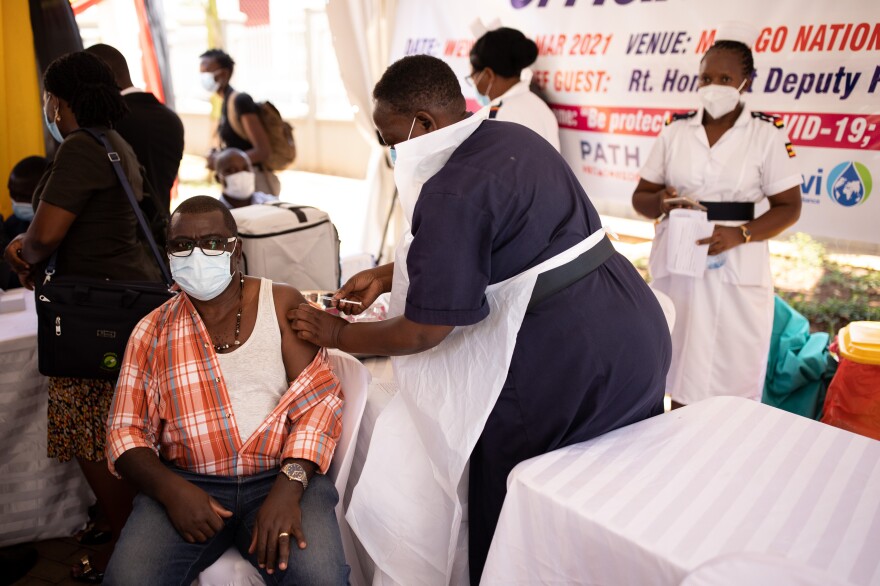 A healthcare professional is vaccinated against COVID-19 in Kampala, Uganda.