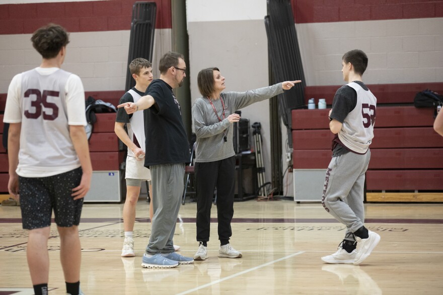 Montrose assistant coach Josh Winn and head coach Tracie McComb show players where to go during practice.