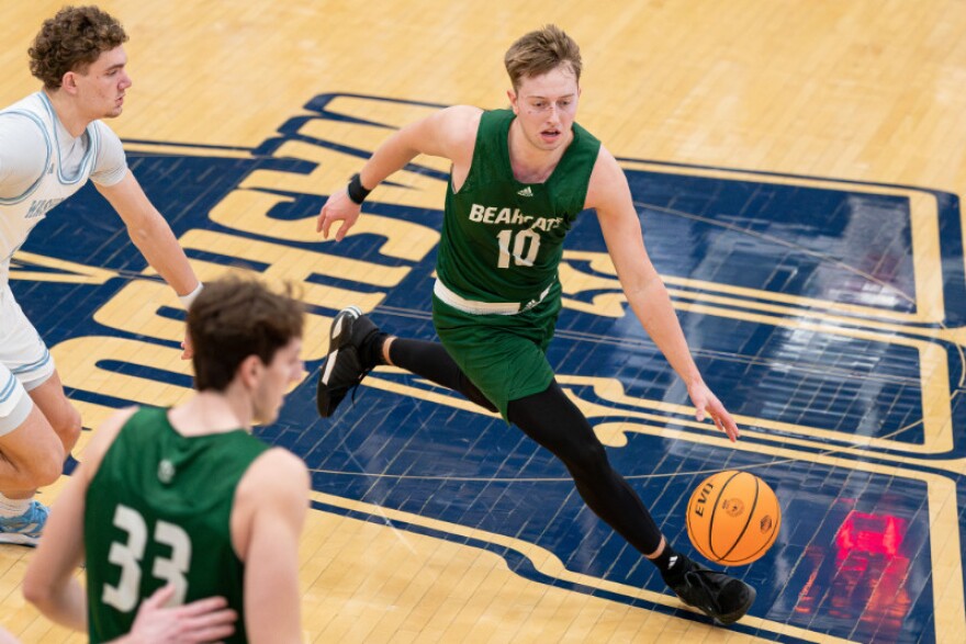 Action shot of G Marcus Glock vs Washburn basketball