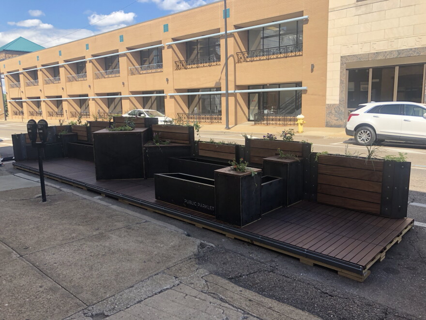 The pocket park is built on a platform that sits atop several parking spaces on North High Street in Akron.