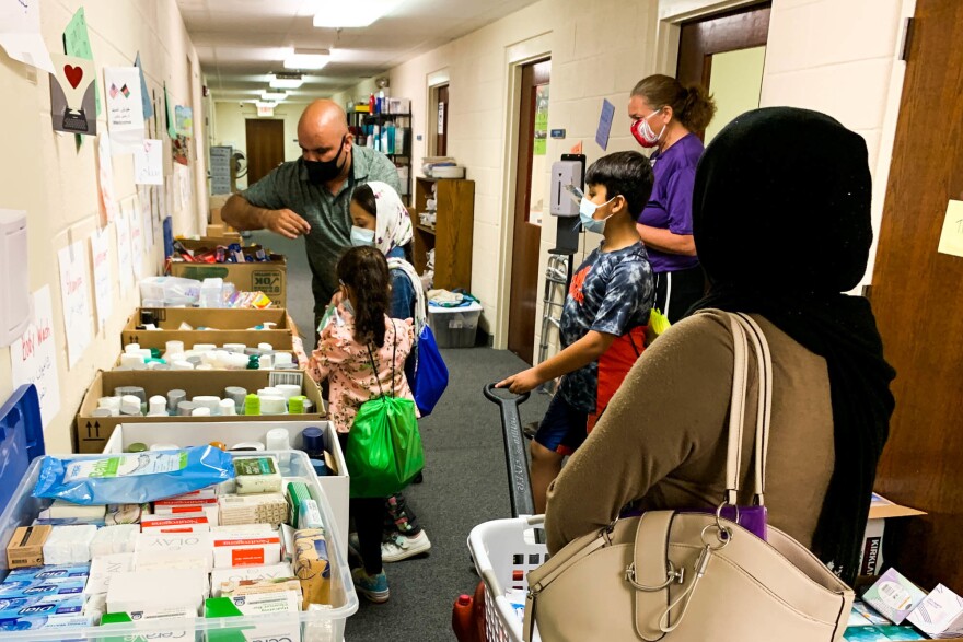 A newly arrived Afghan family stocks up on donated household items at a refugee resettlement office in Fairfax County, Virginia.