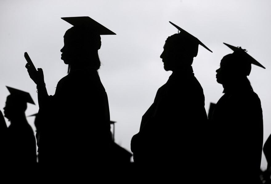 New graduates line up before the start of a community college commencement in East Rutherford, N.J., on May 17, 2018.