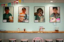 pictures of kids scooping ice cream on a wall in an ice cream shop