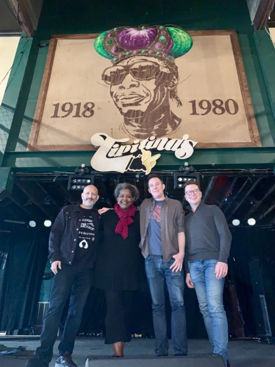 WWNO Music Inside Out Host Gwen Thompkins at Tipitina’s in 2019 with members of Galactic, the venue’s owners.