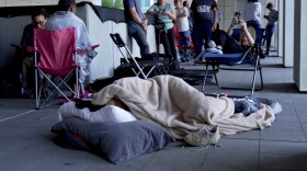 A woman sleeps outside the courthouse in hopes of getting access to the limited public seating available at a preliminary hearing for Tyler Robinson, the Utah man accused of fatally shooting Charlie Kirk, in Provo, Utah, July 9, 2026.