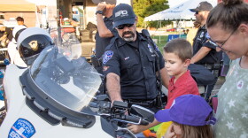 EPD Motor Officer Deon Jordan shows attendees his motorcycle at the Tuesday night event. The EPD were just one of the several local first-responder agencies there. The city fire department, EVSC police, Vanderburgh County Sheriff's Department and airport fire department were also there.