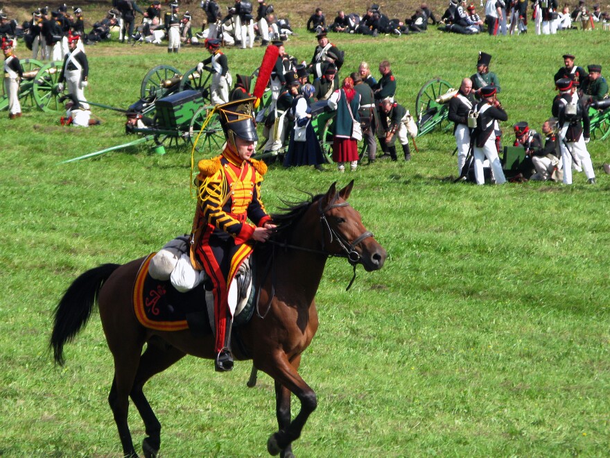 A Russian hussar races past the artillery as the battle is about to begin.