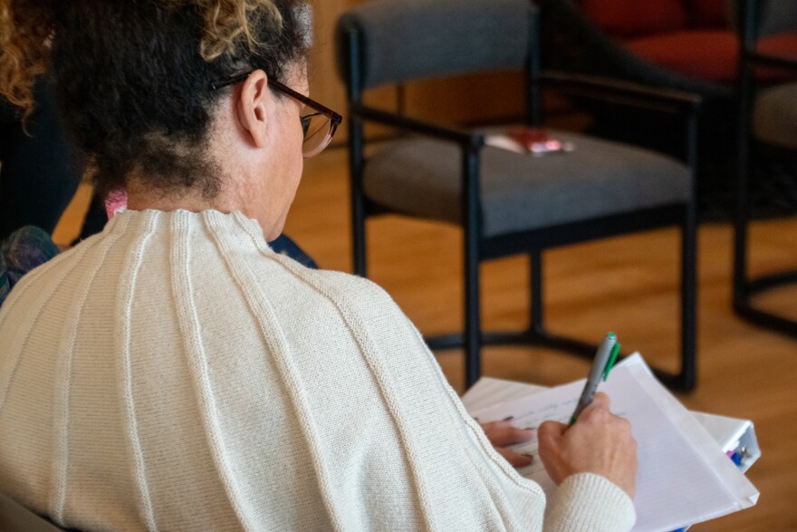 Jennifer Bennet takes notes on her script as she watches another actoress' monologue during rehearsal.