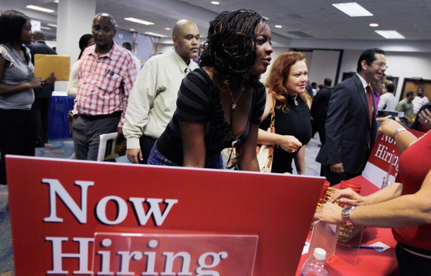 Job seekers met with recruiters during a recent job fair at the James L. Knight Center in Miami.