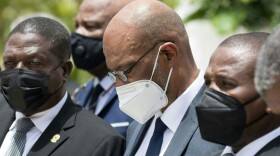 Prime Minister Ariel Henry (center) attends a ceremony in honor of late Haitian President Jovenel Moise at the National Pantheon Museum in Port-au-Prince, Haiti, on July 20, 2021. (Photo by Valerie Baeriswyl Getty Images)