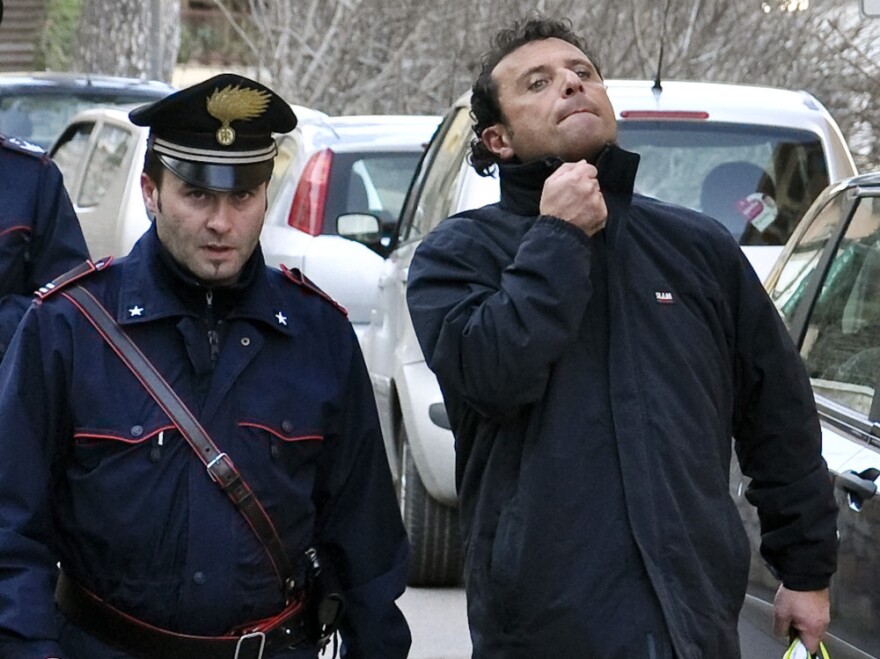 Francesco Schettino, right, the captain of the Costa Concordia cruise liner, has been accused of manslaughter and abandoning the ship. Here he's shown in police custody in Porto Santo Stefano, Italy on Saturday He is now under house arrest.