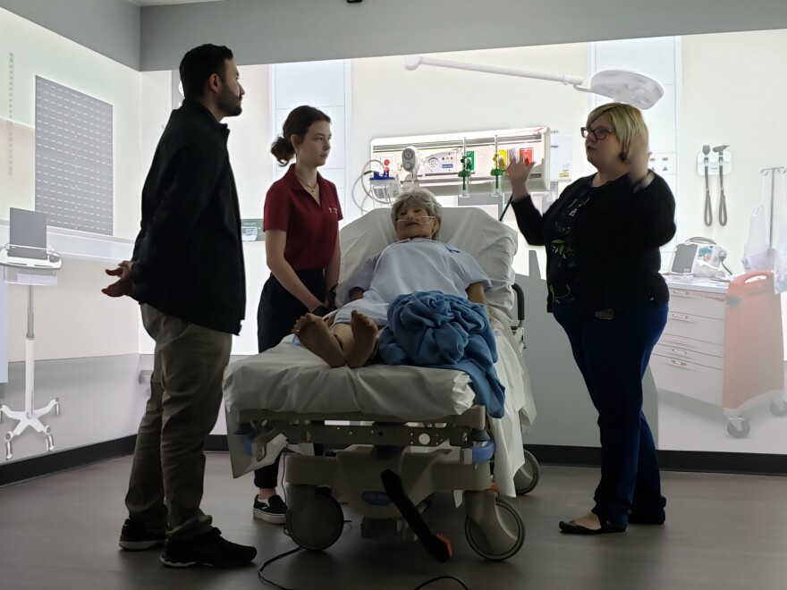 Jennifer Tucker, right) a UCF professor of physical therapy, instructs PT students on the anatomy of the human brain using BLISS, Blended Learning Interactive Simulation Suite.