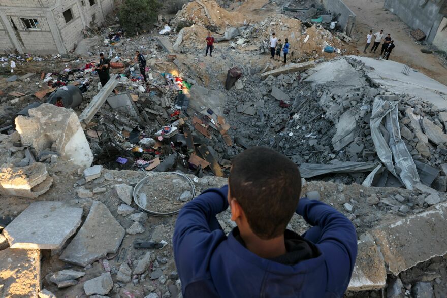 Sat., Oct. 21: A young boy looks on as people check the rubble of a building destroyed in an Israeli bombardment in Rafah.