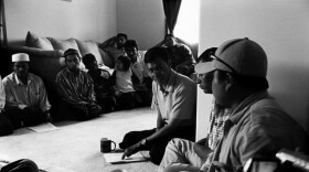 Taking the role of organiser and activist, Myo Myint addresses a meeting of Burmese Muslim refugees in his brother's house in Fort Wayne, Indiana.