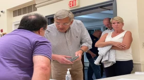 Bob Stefanowski consulting with Bill Evans, a supporter, while his running mate, Laura Devlin watches on the night of the Independent Party caucus last month.