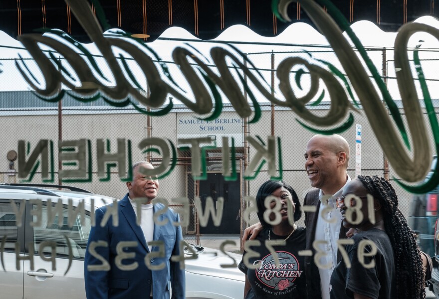 Senator and 2020 presidential hopeful Cory Booker greets supporters outside Vonda's Kitchen in Newark, N.J.