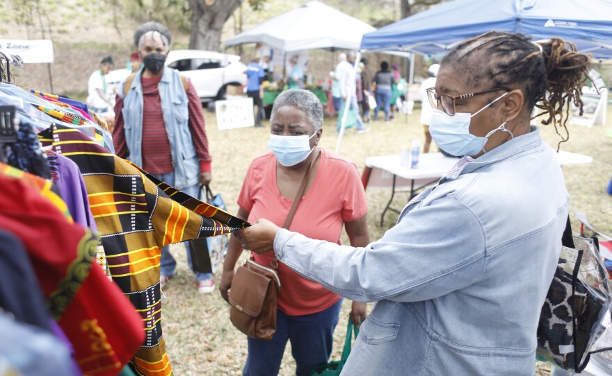 Joan Crawford and Linda McFadden shop for African clothing during the 2022 Publix Tampa Bay Collard Festival in St. Petersburg, Florida, on Saturday, February 19, 2022. Photo by Octavio Jones for WUSF