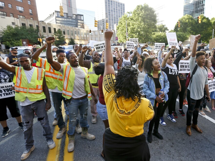 Marchers in East Pittsburgh, Pa., raise their fists Tuesday as they protest the shooting death of Antwon Rose II.