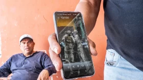 Francisco Gonzalez-Jasso shows the video of his arrest by federal agents in Chicago. The video circulated on social media, spreading word of his arrest and deportation before he arrived back home.