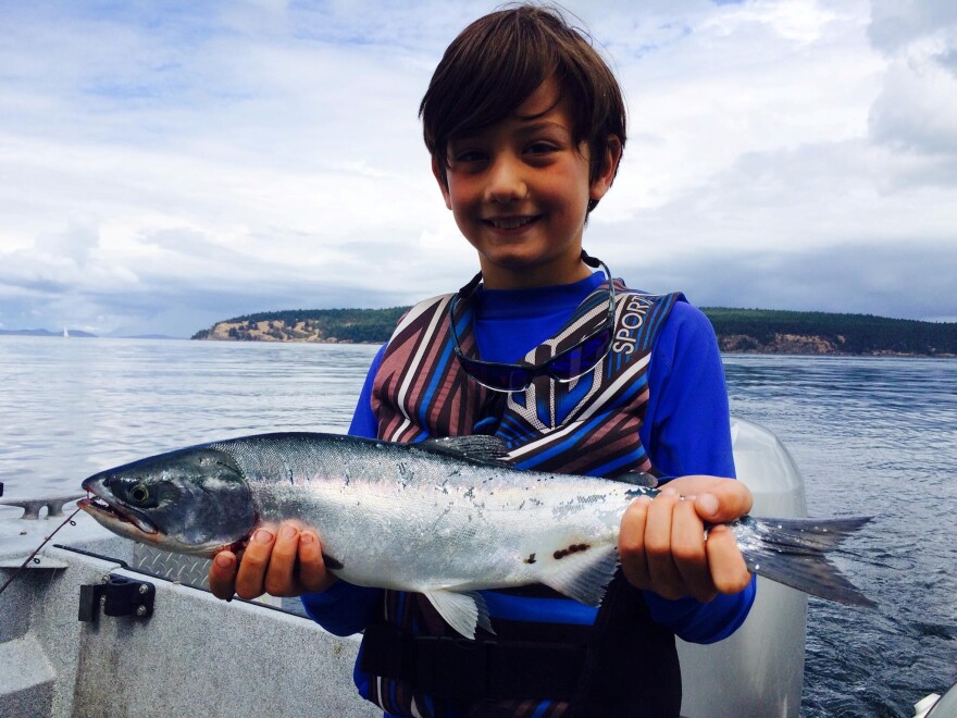 An 8-year-old boy catches a pink salmon in the San Juans off Orcas Island.