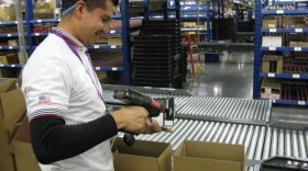 Javier Polendo, an employee at a largely automated Target.com fulfillment center in Tucson, Ariz., scans items to be shipped to online customers.