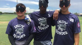Indy Thunder players pose with their blindfolds. (Allison Light/WLRN News)