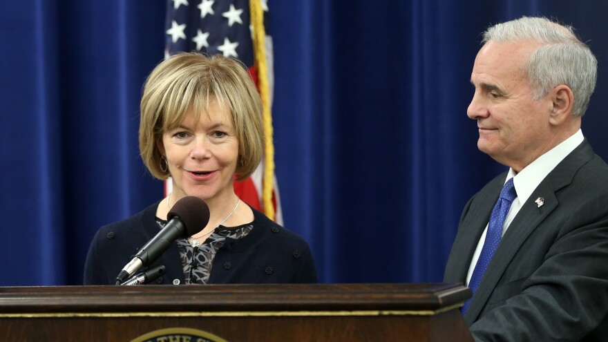 Democratic Gov. Mark Dayton holds a news conference in 2014 with running mate Tina Smith in St. Paul, Minn. Dayton has named Smith to take Al Franken's seat in the U.S. Senate.