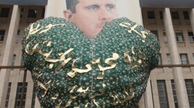 Syrian demonstrators hold up a balloon for Valentine's Day in front of a portrait of President Assad, during a rally to show their support for their leader Damascus on Feb. 14, 2012. In the U.S., some fear that Valentine's Day has become serious business.