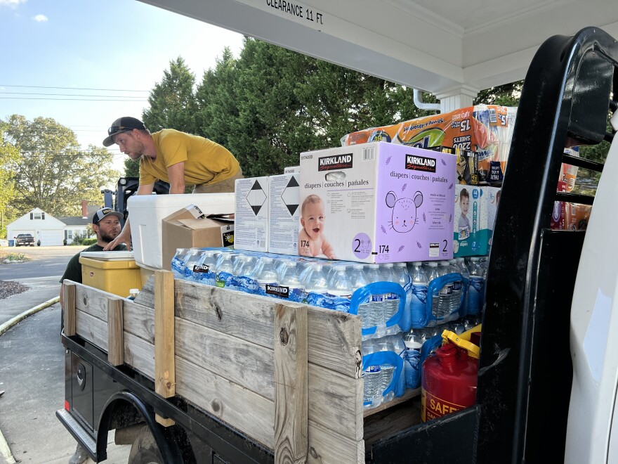 Employees at Aeroflow passing out supplies.